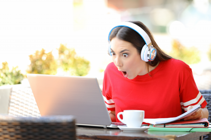 Surprised woman in front of laptop